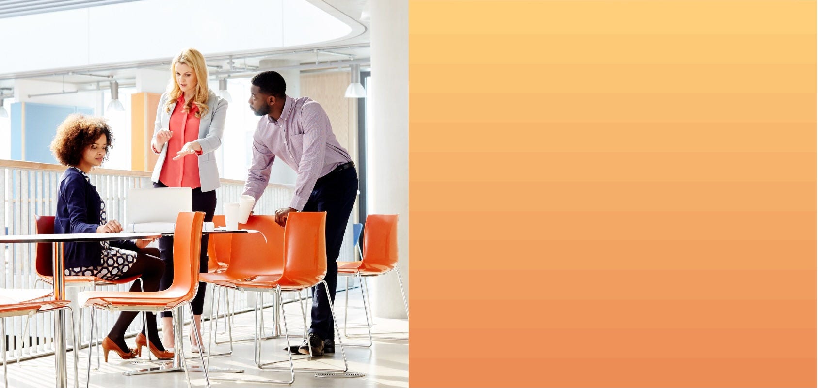 Work colleagues have a discussion in their office's break area.