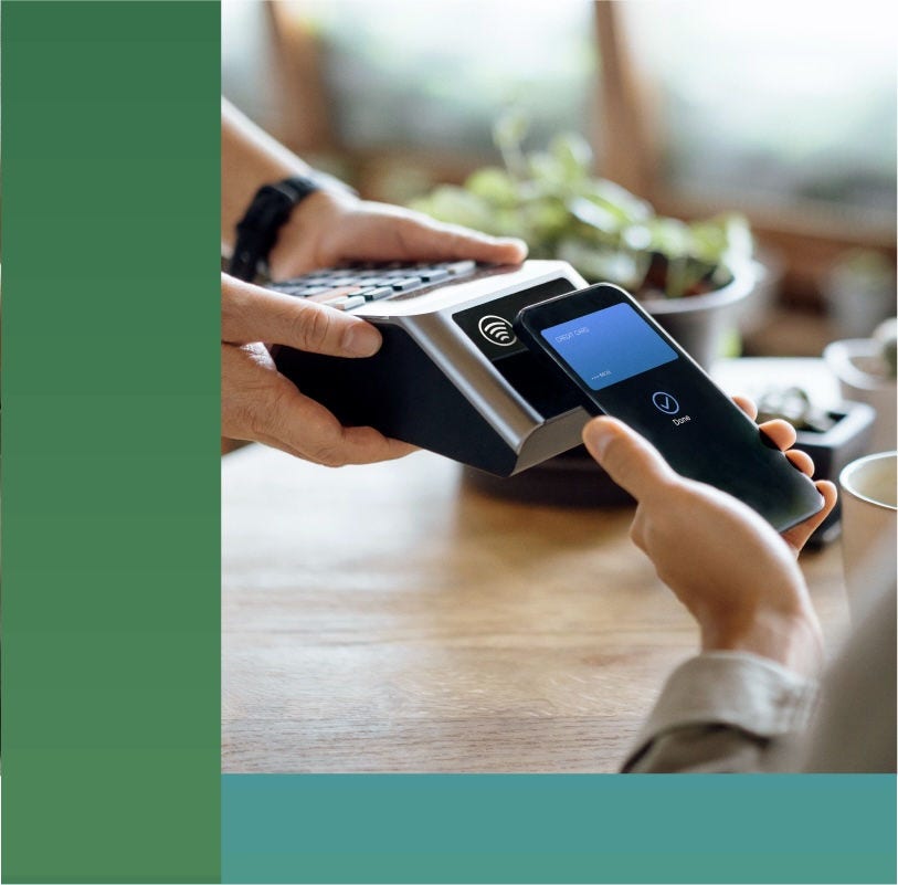 A customer using their phone on a point-of-sale device to purchase coffee.