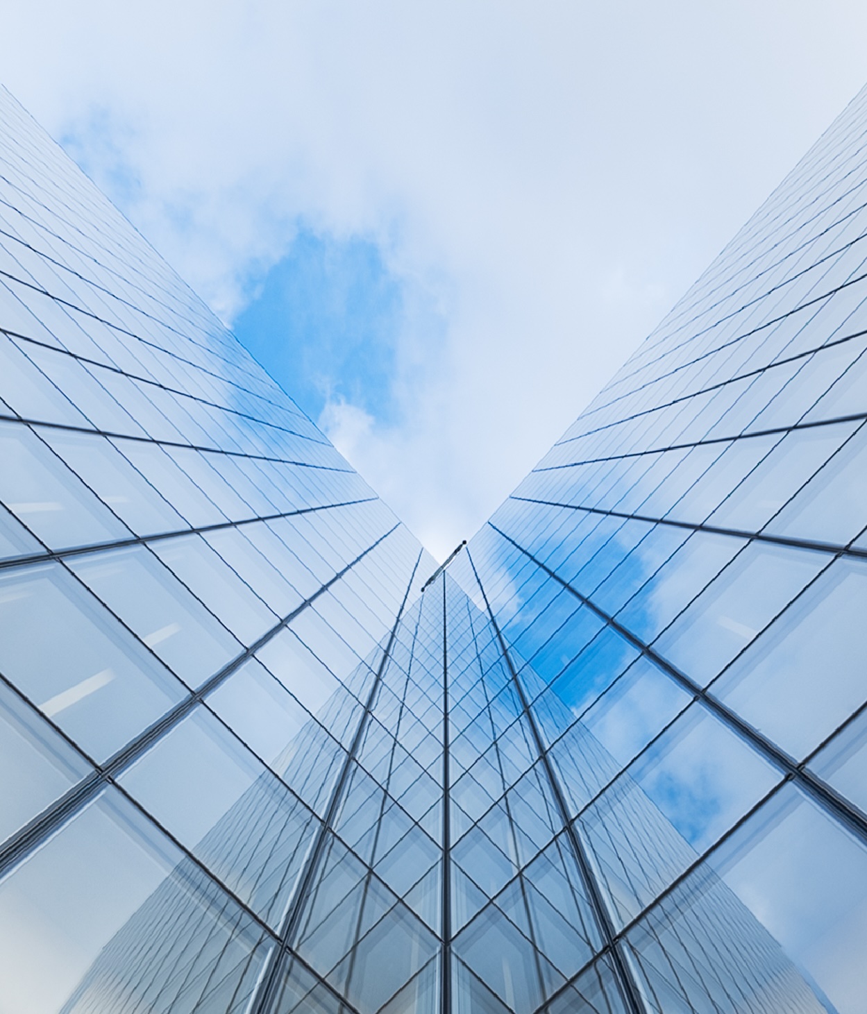 Low angle shot looking up at an angled office building.
