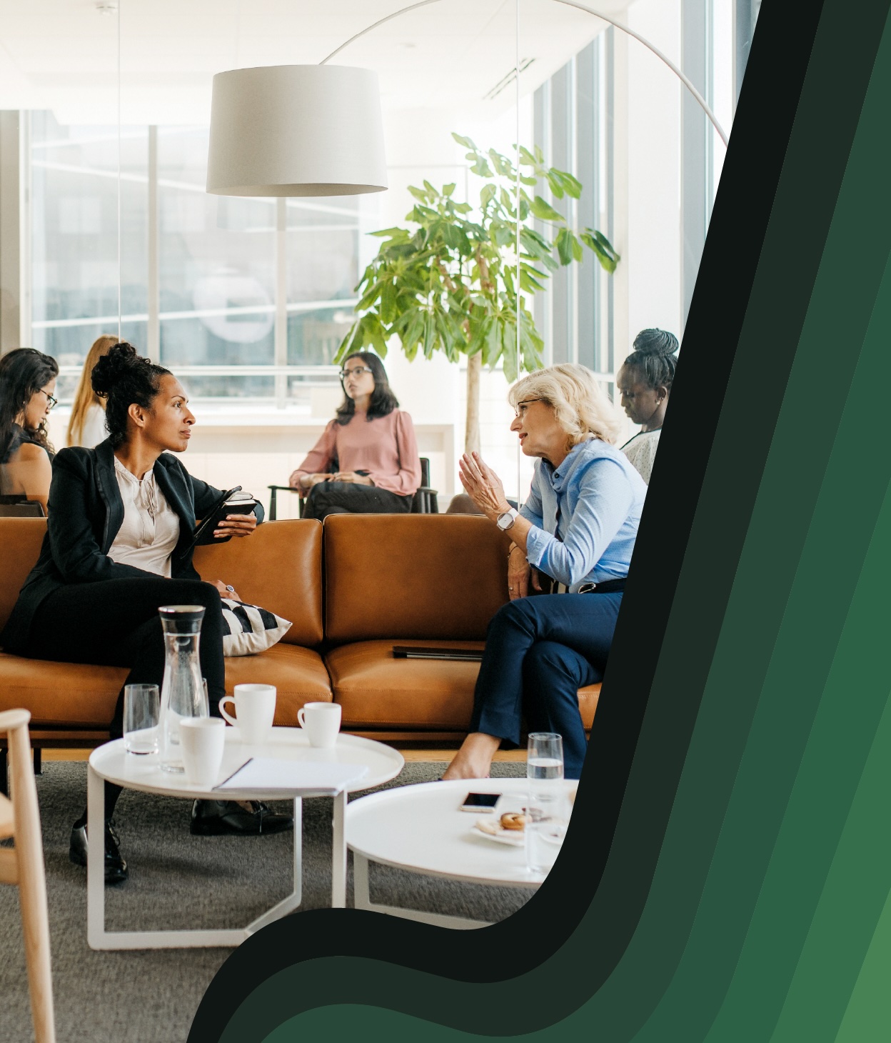 Professional women chat in an office lounge
